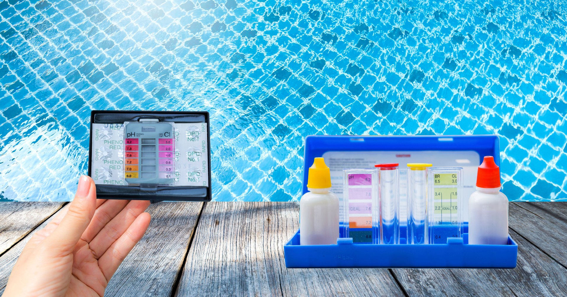 Swimming pool water tester test kit over clear pool water background